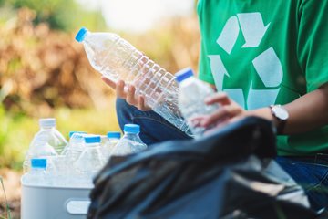 Recycling image with person holding plastic bottles